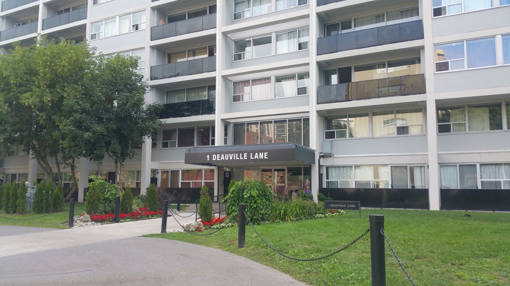A building with the name 1 Deauville Lane on it.