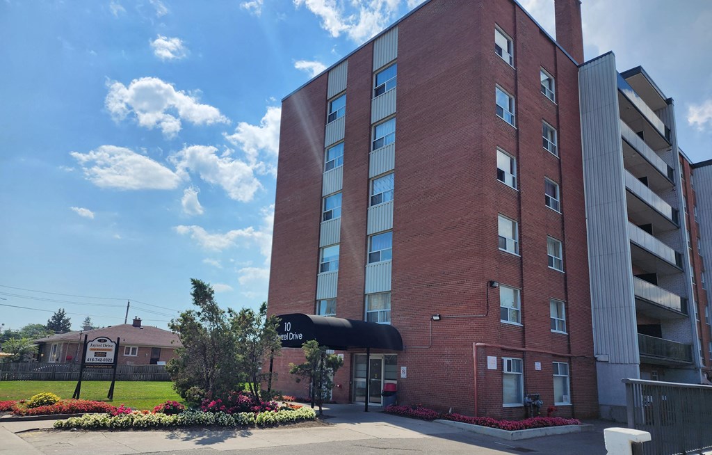 A red brick building with a black awning and a sign that reads "10 Jayzel Drive.".