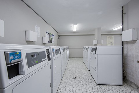 A row of washing machines in a laundromat.