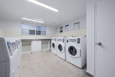 A laundry room with washers and dryers.