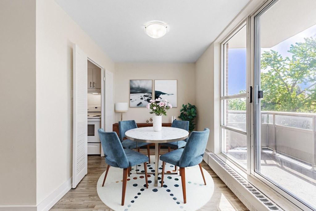 A dining room with a table and chairs.