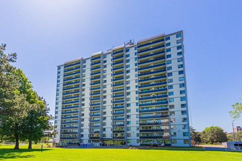 A tall residential building with many windows and balconies.