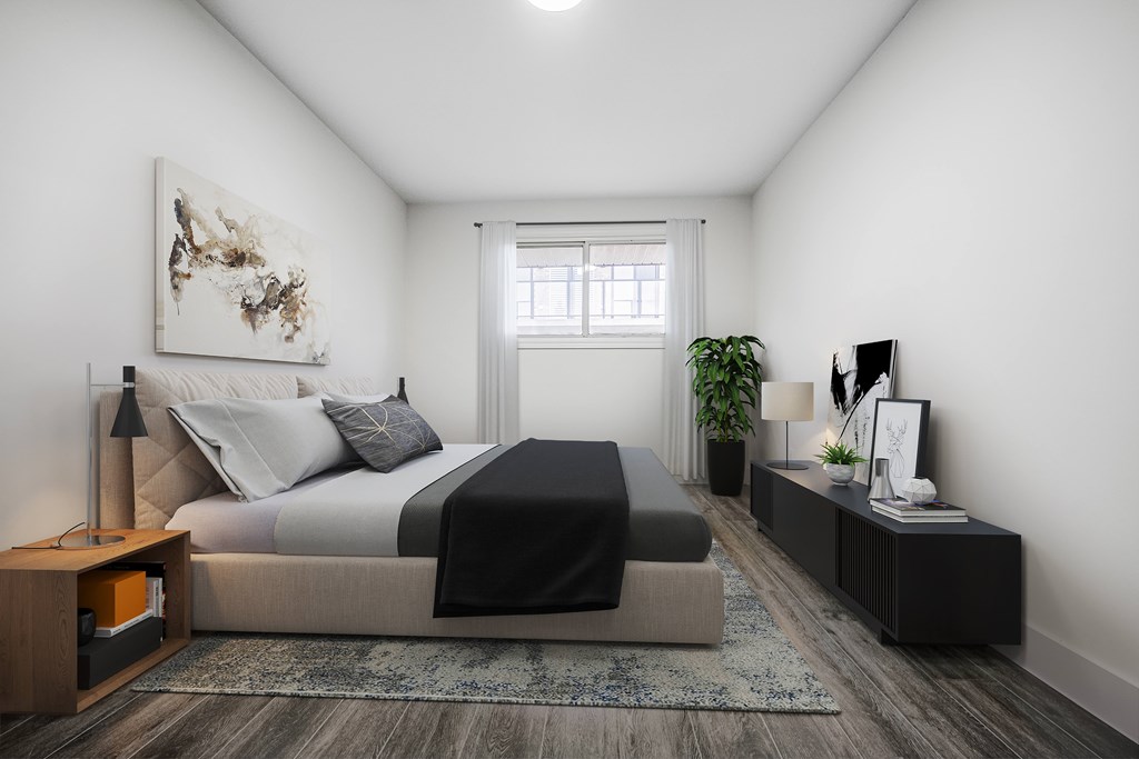 A modern bedroom with a large bed and a painting on the wall.