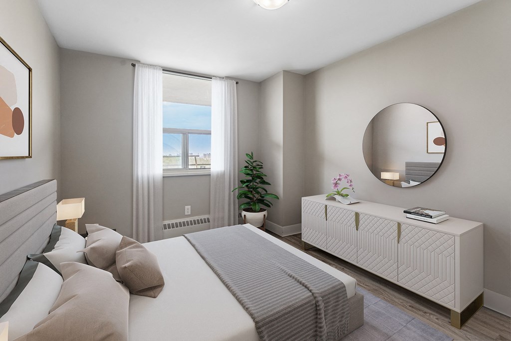 A bedroom with a large bed, a mirror, and a window with curtains.