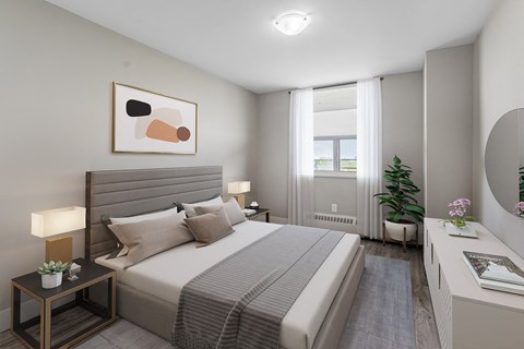 A well-lit bedroom with a large bed and a painting on the wall.