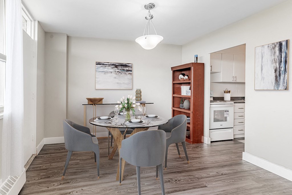 A dining room with a table set for four.