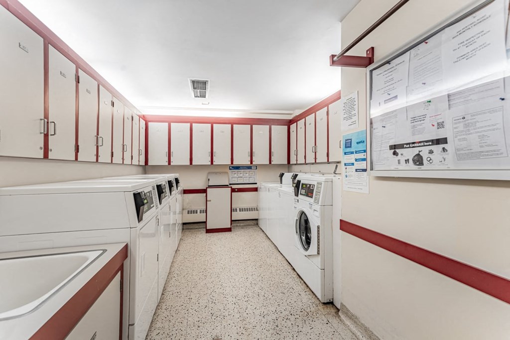 A laundry room with washers and dryers.