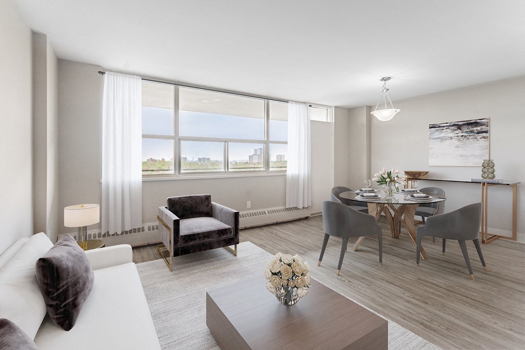 A modern living room with a large window and a dining area.