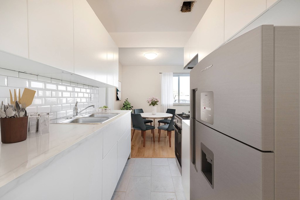 A modern kitchen with a dining table and chairs.