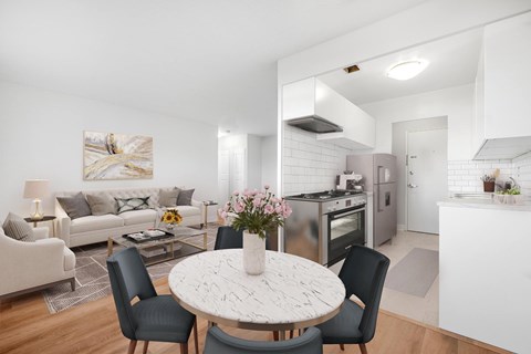 A modern kitchen with a dining table set for four.