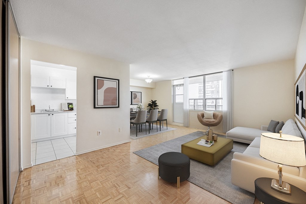 A living room with a couch, chair, and ottoman.