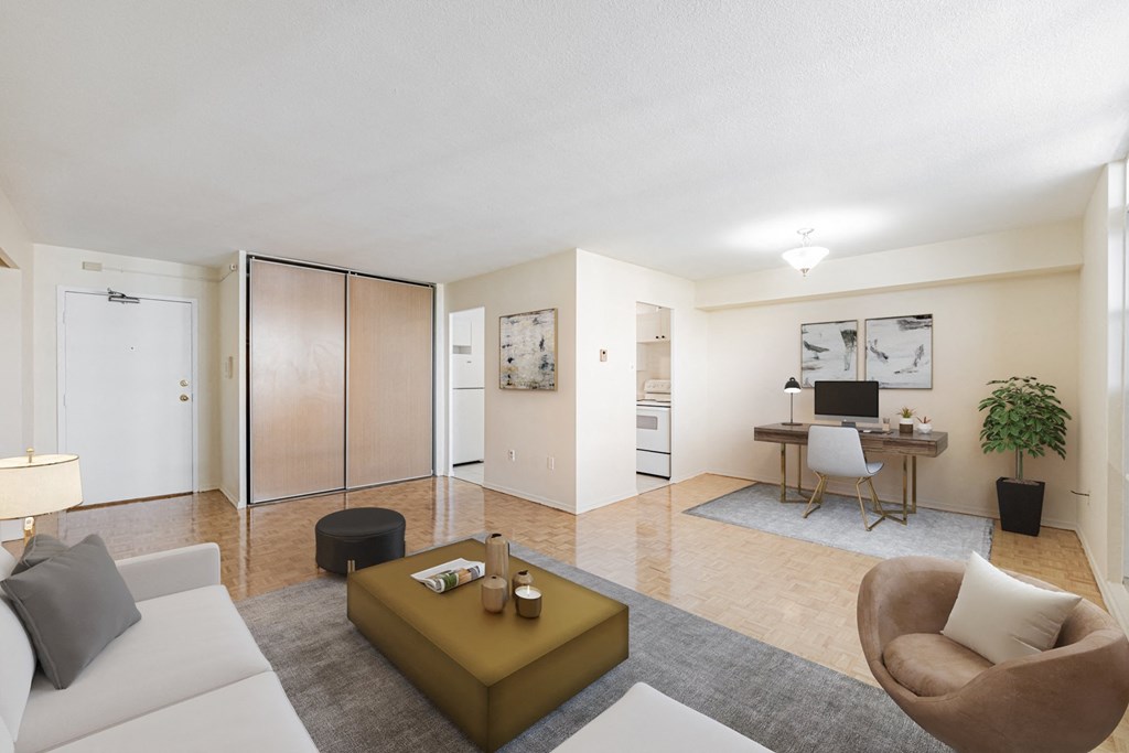 A modern living room with a white sofa, a brown armchair, and a coffee table.