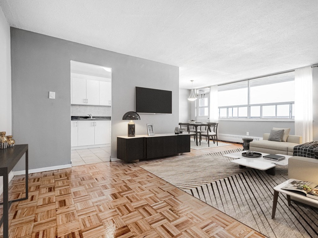 A modern living room with a wooden floor and a flat screen TV.