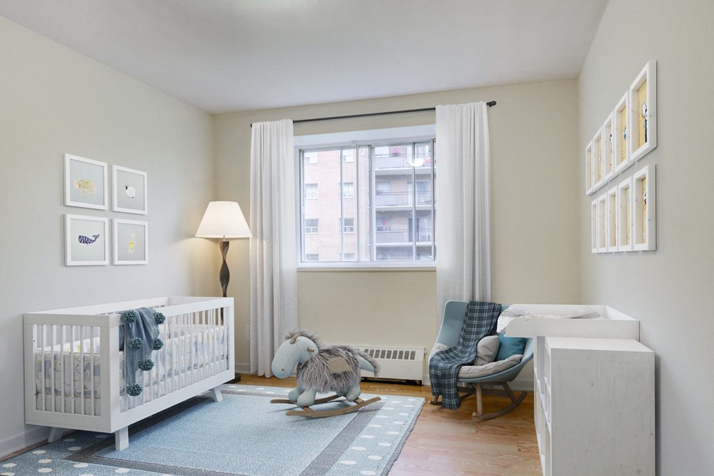 A nursery room with a crib, rocking horse, and a chair.