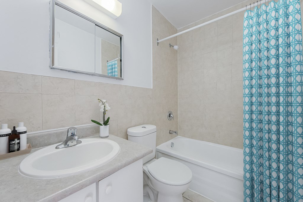 A white sink with a mirror above it in a bathroom.