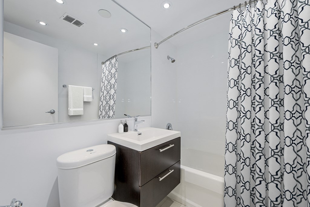A white toilet sits next to a sink in a bathroom.