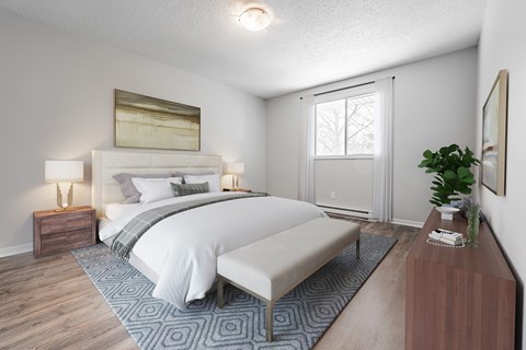 A bedroom with a large bed and a bench.