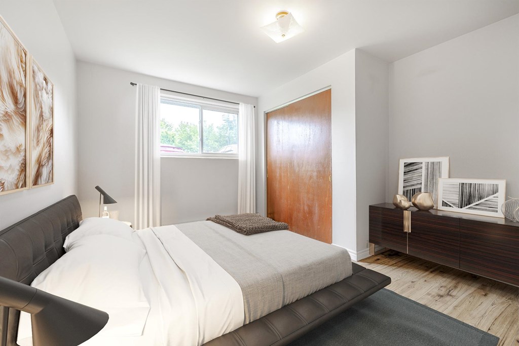 A bedroom with a large bed and a wooden door.