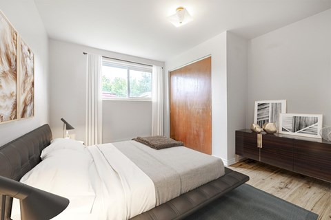 A bedroom with a large bed and a wooden door.