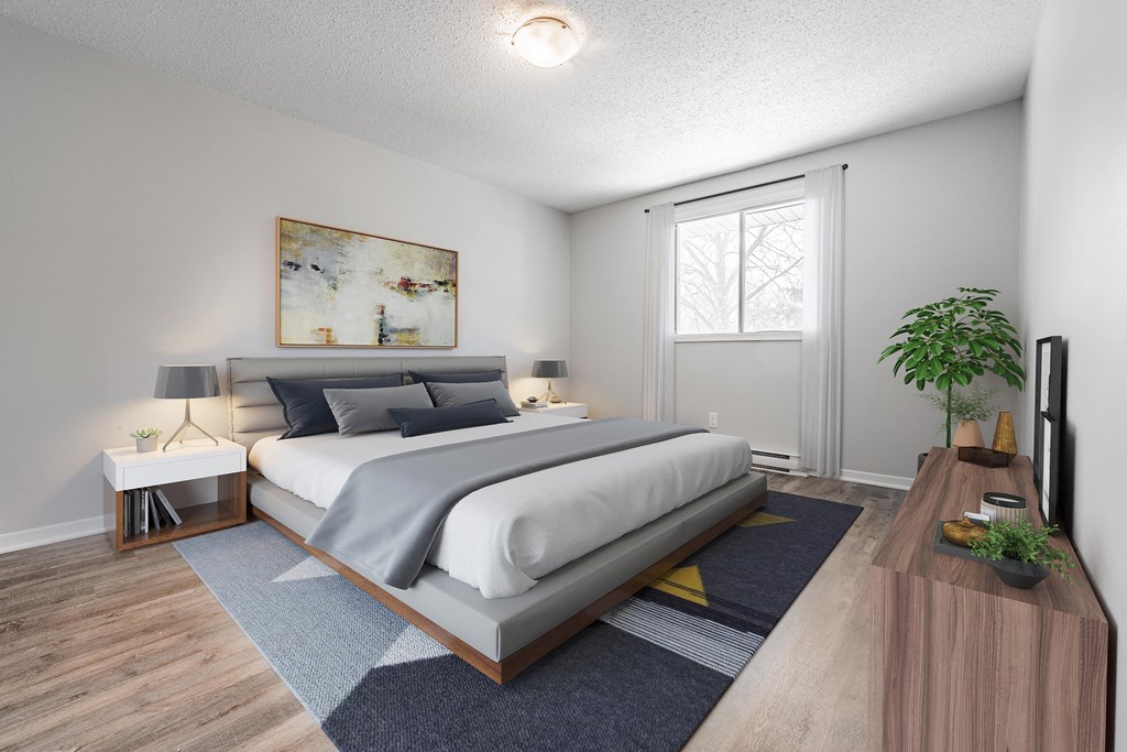 A bedroom with a large bed and a painting on the wall.