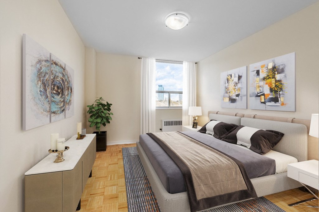 A bedroom with a large bed and a painting on the wall.