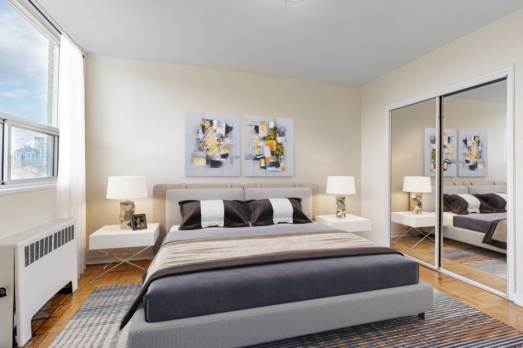 A bedroom with a large bed and a painting above it.