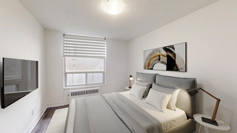 A bedroom with a large bed and a painting on the wall.
