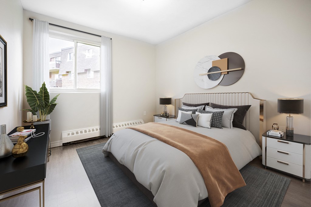 A bedroom with a large bed and a window.