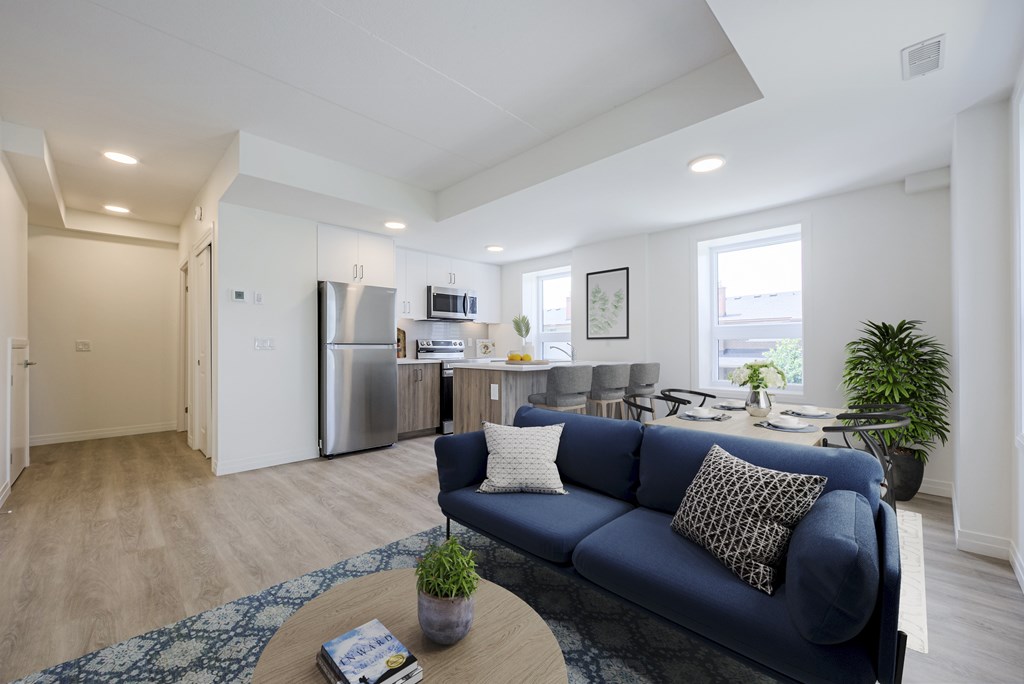 A blue couch sits in a living room with a coffee table in front of it.