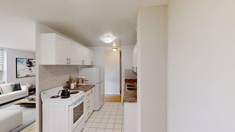 A white kitchen with a white oven and white cabinets.