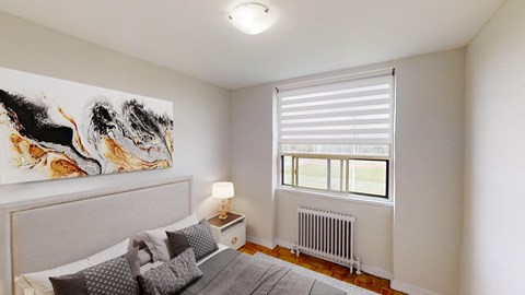 A bedroom with a large painting on the wall and a bed with pillows.