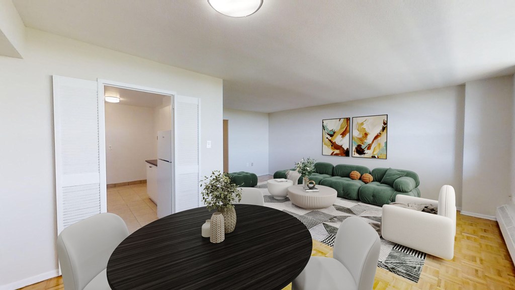 A modern living room with a black table and white chairs.