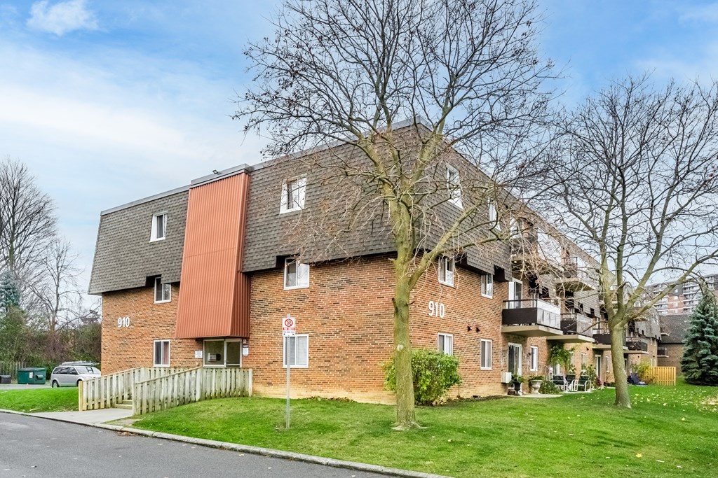 A red brick building with a white sign on it.