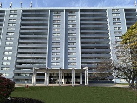 A large grey building with a lot of windows and balconies.