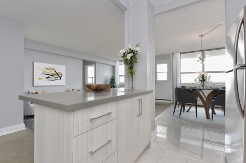A modern kitchen with a dining table and chairs.