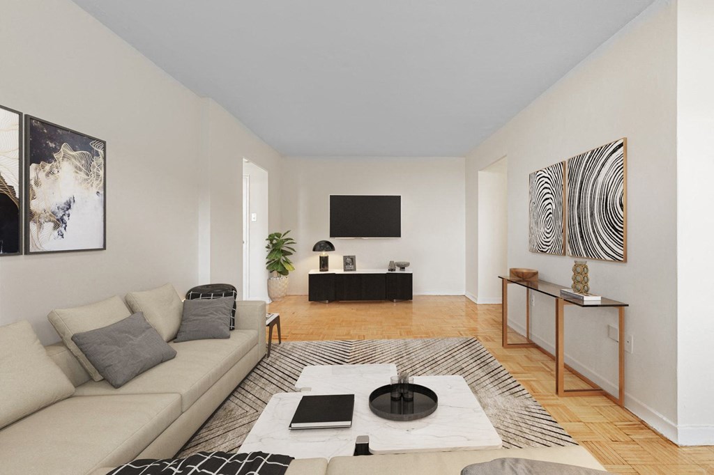 A living room with a couch, coffee table, and a television.