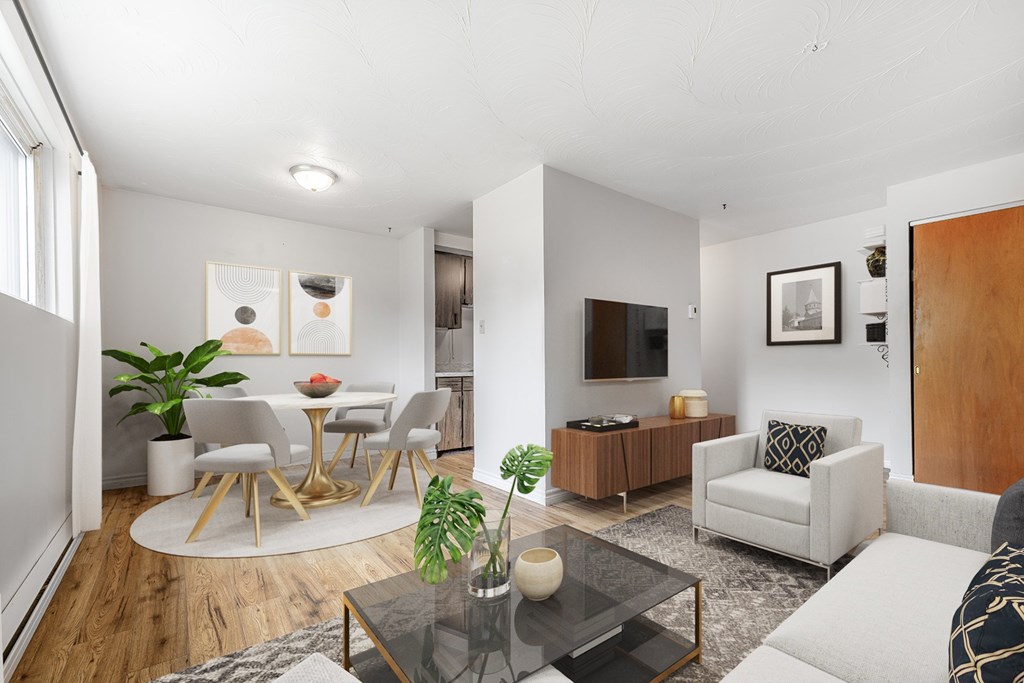 A modern living room with a glass coffee table and a white sofa.