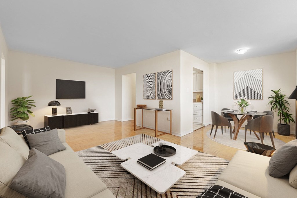 A modern living room with a white couch, a coffee table, and a television.