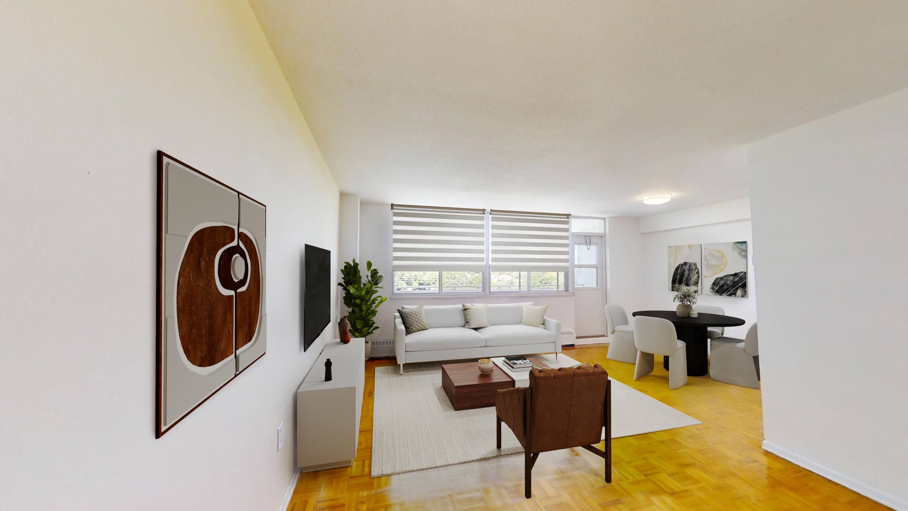 A living room with a white couch and a brown chair.
