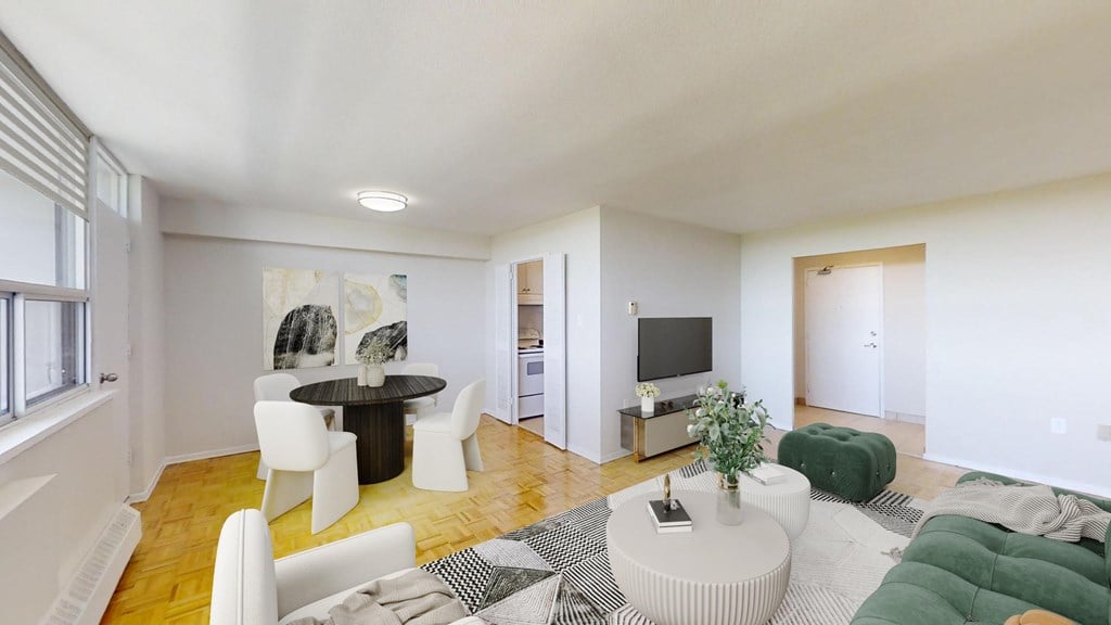 A living room with a white couch and a green cushion.