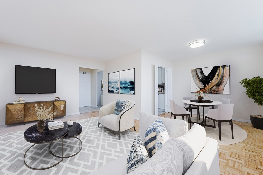 A living room with a white couch, a coffee table, and a painting on the wall.