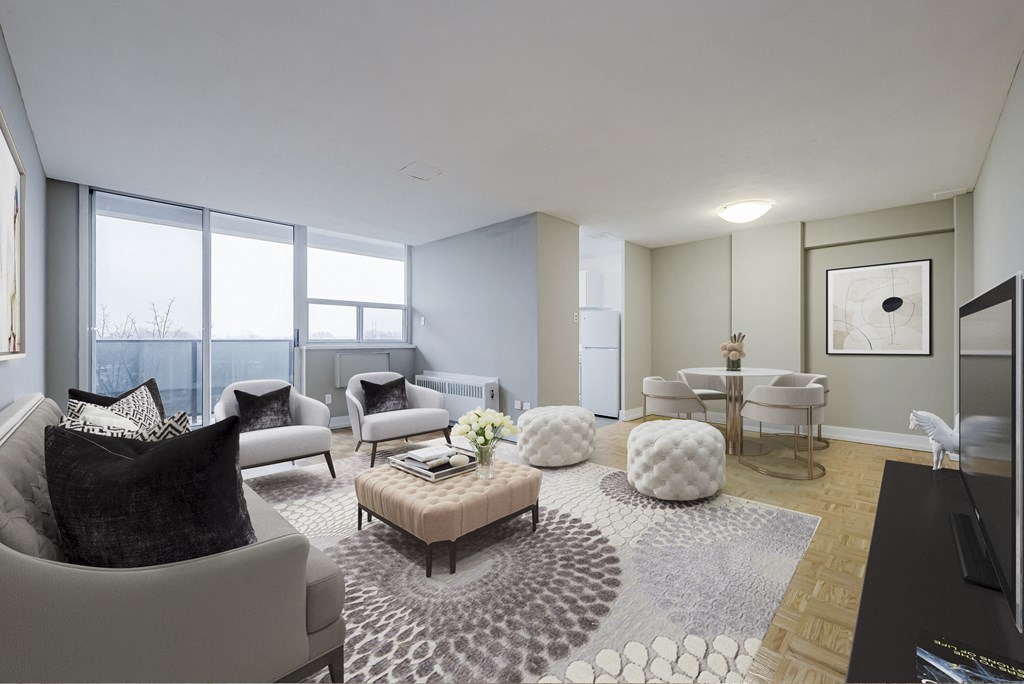 A modern living room with a grey sofa and a patterned rug.