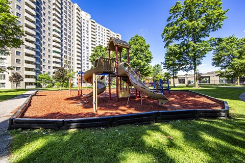 A playground with a slide and a wooden structure.