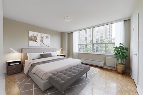 A bedroom with a large bed and a plant.