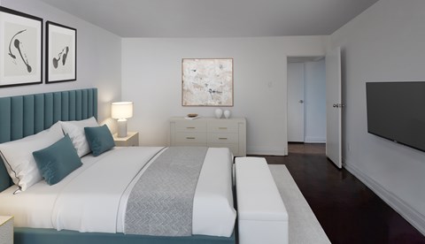 A bedroom with a bed, a nightstand, and a dresser.
