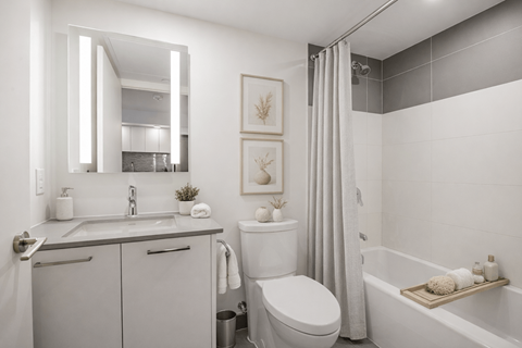 A bathroom with a white toilet, sink, and bathtub.