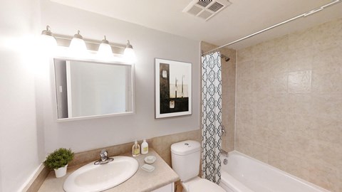 A bathroom with a sink, toilet, and bathtub.