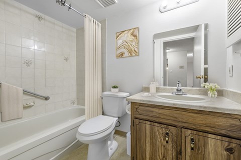 A white toilet sits next to a white sink in a bathroom.