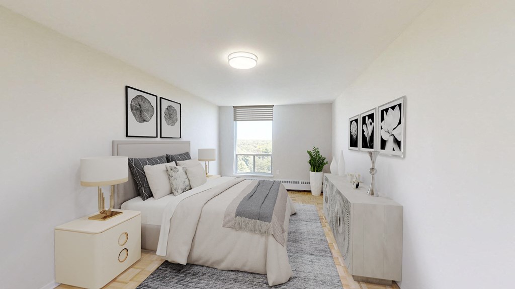 A bedroom with a bed, nightstand, and pictures on the wall.