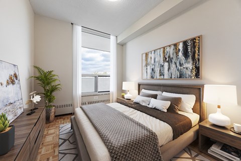 A well-lit bedroom with a large bed and a painting on the wall.